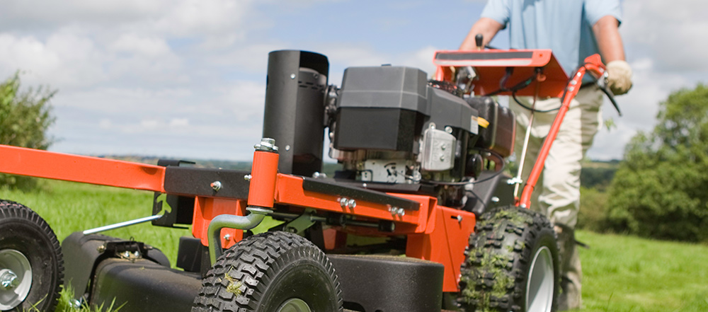 man operating lawn mower