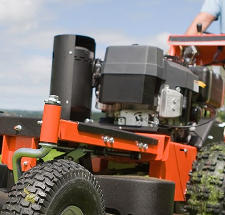 man operating lawn mower